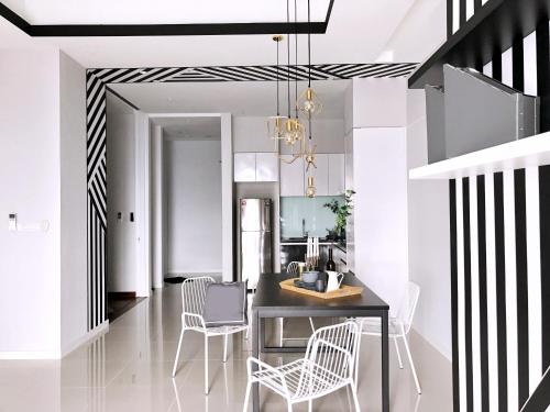 a dining room and kitchen with black and white stripes at Azure Residences by Sleepy Bear Paradigm Mall in Petaling Jaya