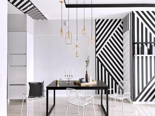 a dining room with a black table and chairs at Azure Residences by Sleepy Bear Paradigm Mall in Petaling Jaya