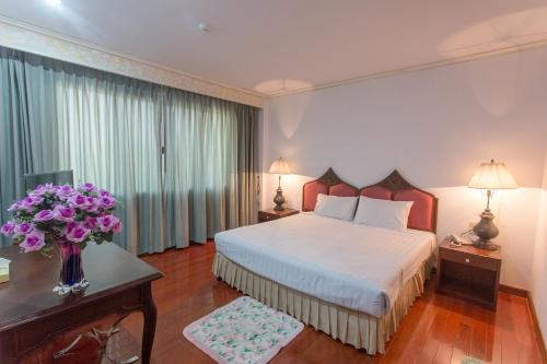 Ένα ή περισσότερα κρεβάτια σε δωμάτιο στο Tangerine Ville Hotel