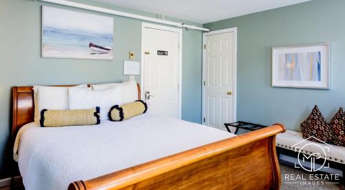 a bedroom with a bed with blue walls at Bouchard Restaurant & Inn in Newport