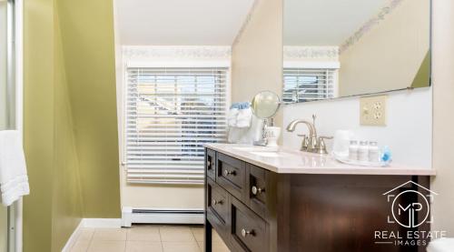 a bathroom with a sink and a mirror at Bouchard Restaurant & Inn in Newport