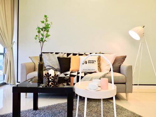 a living room with a couch and a coffee table at Azure Residences by Sleepy Bear Paradigm Mall in Petaling Jaya