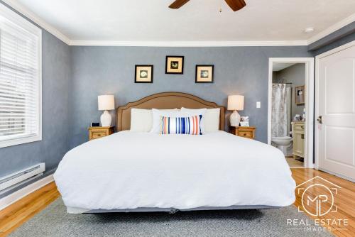a bedroom with a large white bed and blue walls at Bouchard Restaurant & Inn in Newport