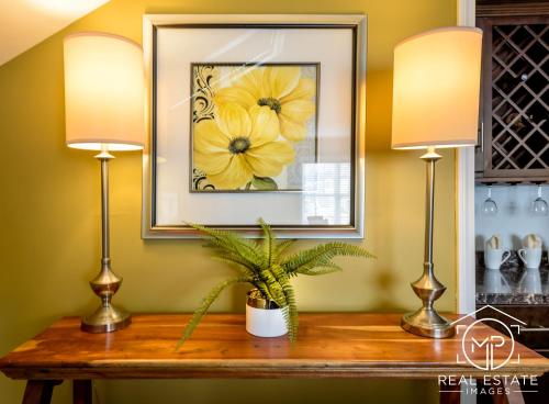 two lamps on a table with a picture of yellow flowers at Bouchard Restaurant & Inn in Newport