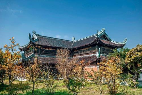 a large building with a roof in a park at Ninh Binh Brother's Homestay in Ninh Binh