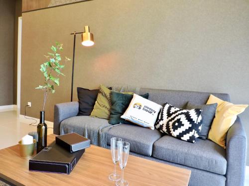 a living room with a couch and a coffee table at Azure Residences by Sleepy Bear Paradigm Mall in Petaling Jaya