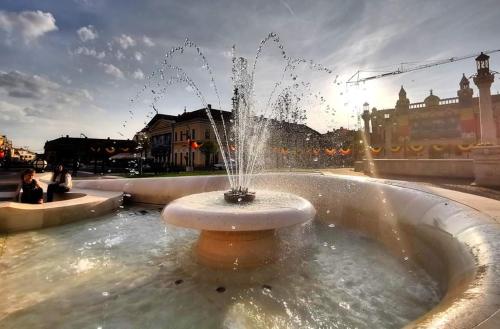 a fountain in the middle of a street with a person at Sia & Sophie House Oradea in Sîntandrei
