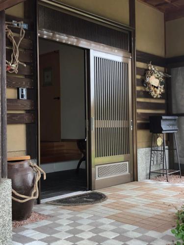 an entrance to a house with a glass door at familie in Otsu