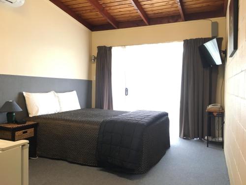 Ένα ή περισσότερα κρεβάτια σε δωμάτιο στο Thornton Lodge Motel
