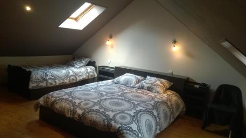 a bedroom with two beds in a attic at WELCOME Bayeux in Bayeux