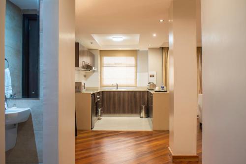 a kitchen with a sink and a counter top at Longonot Place Serviced Apartments in Nairobi