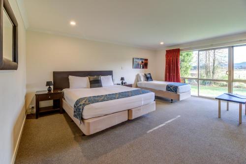 a hotel room with two beds and a window at Hanmer Springs Retreat in Hanmer Springs