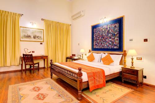 A bed or beds in a room at WelcomHeritage Shivavilas Palace, HAMPI