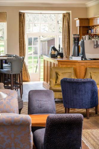 a living room with chairs and a table at Losehill House Hotel & Spa in Hope