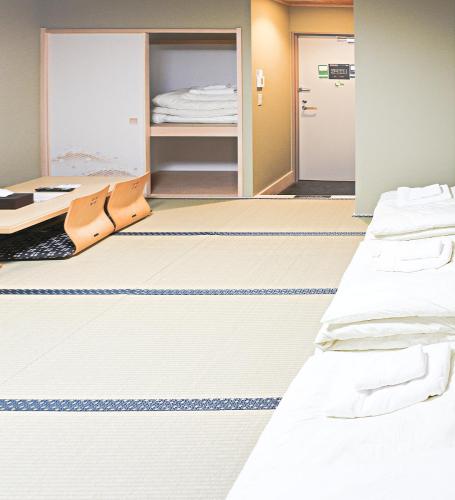 a hospital room with two beds and a closet at Akihabara Nakagawa Inn in Tokyo