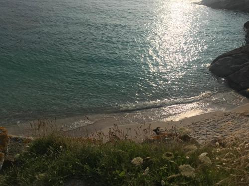 a view of a beach with the ocean at Le Clos de la Pointe Saint-Mathieu in Plougonvelin