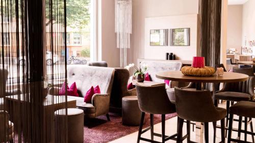 a living room with a table and chairs at City Hotel Merano in Merano