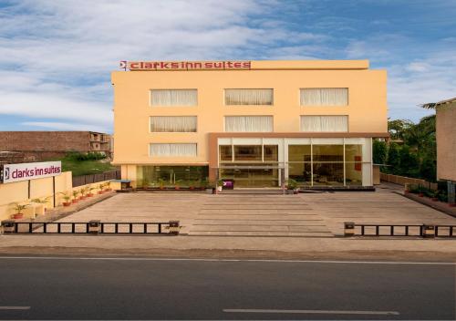 a large yellow building with stairs in front of it at Clarks Inn Suites Katra in Katra
