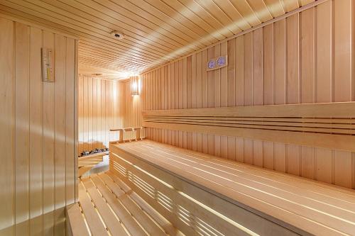 a sauna with wood paneled walls and wooden floors at Medical SPA "Eglės sanatorija" Comfort Druskininkai in Druskininkai