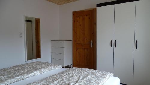 a bedroom with a bed and a dresser and a door at Ferienwohnung Karin Humer in Bad Ischl