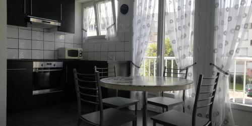 a kitchen with a table and chairs and a window at Appartement Le Tréport Centre in Le Tréport