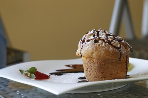una magdalena de chocolate en un plato en una mesa en Open House Boutique, en Manzini
