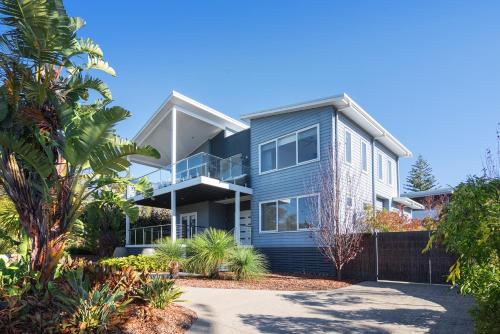 an image of a house with palm trees at Casa Azzura - beachside entertainer in Dunsborough