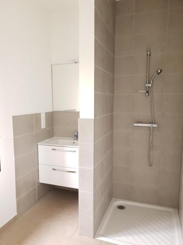 a bathroom with a shower and a sink at Gîtes de Maurs in Maurs