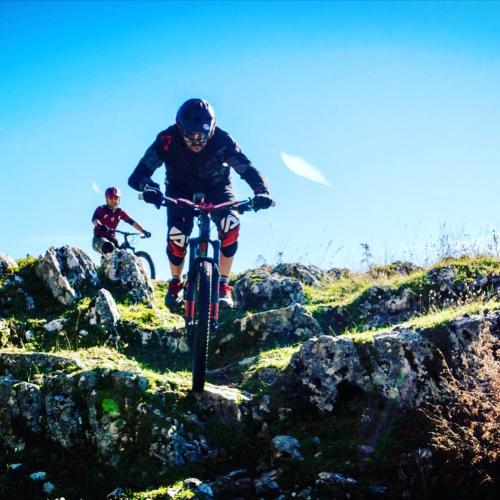 two people riding bikes on a rocky trail at Hotel Campo Felice in Lucoli Alto
