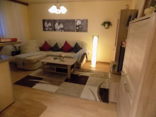 a living room with a couch and a table at Haus Alexandra in Schöneberg