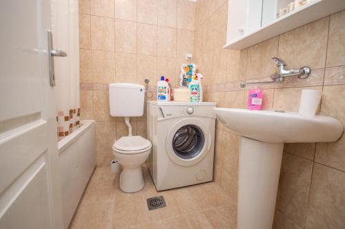 a bathroom with a washing machine and a sink at Apartment Nikolic Kotor in Kotor