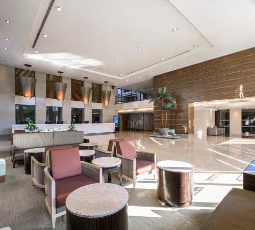 a lobby of a hotel with tables and chairs at Lakeshore Hotel Hsinchu in Hsinchu City