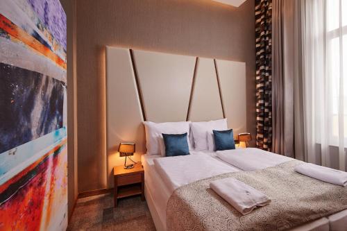 Postel nebo postele na pokoji v ubytování Artis Boutique Hotel
