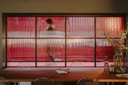 a room with a large window with a table and chairs at Supernova Hotel in Rotterdam