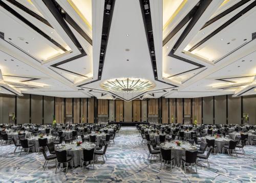a ballroom with tables and chairs in a room with ceilings at Fairmont Singapore in Singapore