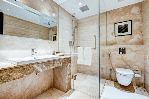 a bathroom with a toilet and a sink and a shower at THE WAY Dhaka in Dhaka