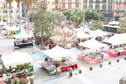 an overhead view of an outdoor market with white tents at MyB in Naples