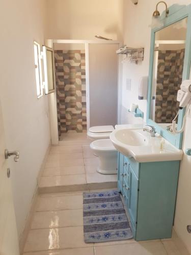 a bathroom with a sink and a toilet at All'Ombra Del Noce B&B in Catona
