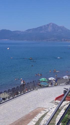 a beach with people swimming in the water at Residenza Longobardi in Vibonati