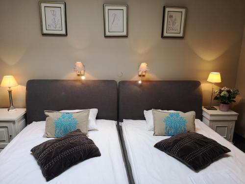 a bedroom with a large bed with two pillows at Riviera Resort Airport Modlin in Olszewnica Nowa