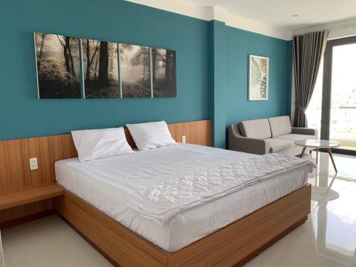 a bedroom with a bed and a blue wall at 319 Liên Phường, Q9 in Ho Chi Minh City