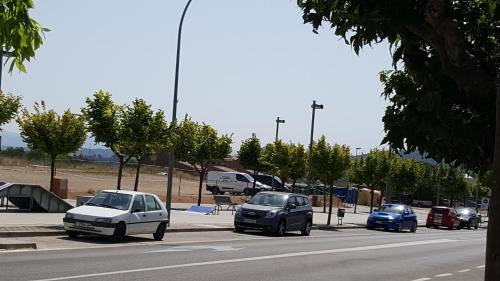a group of cars parked on the side of a road at Apartament Torrellenc in Torrellas de Foix