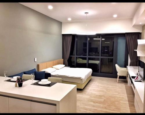 a bedroom with a bed and a living room with a kitchen at M CITY Kl City in Kuala Lumpur