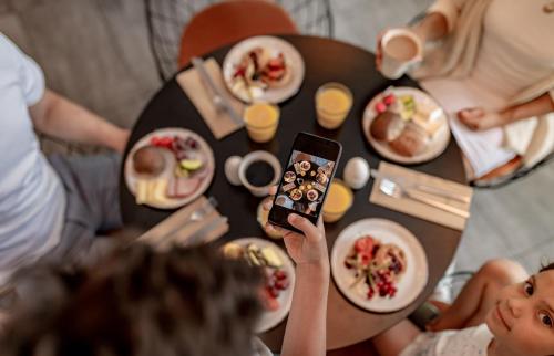 a person taking a picture of a table with food at Best Western Malmo Arena Hotel in Malmö