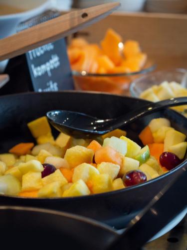 a bowl of fruit with a spoon in it at Radisson Blu Hotel, St. Gallen in St. Gallen