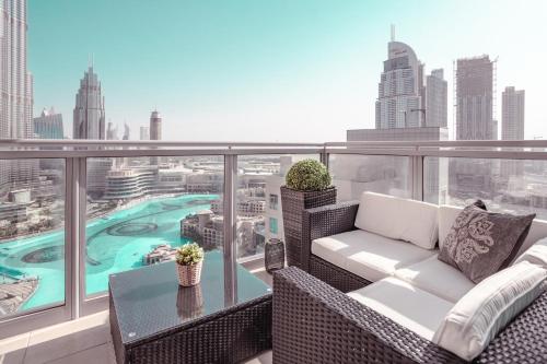 a balcony with a couch and a table with a view at Elite Royal Apartment - Full Burj Khalifa & Fountain View - Deluxe in Dubai