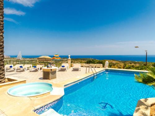 a swimming pool with a view of the ocean at Villa Cala Torta Na Lluny by Interhome in Cala Mesquida