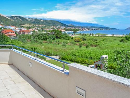 a balcony with a view of the water at Apartment Jadranka-2 by Interhome in Rab