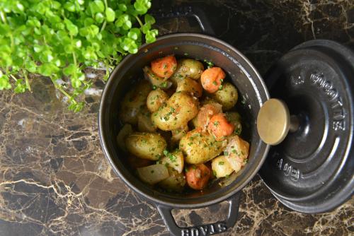 a pot filled with potatoes and carrots on a counter at Chateau La Cheneviere in Port-en-Bessin-Huppain