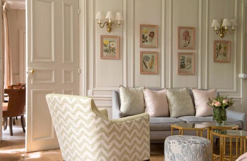a living room with a couch and a table at Chateau La Cheneviere in Port-en-Bessin-Huppain